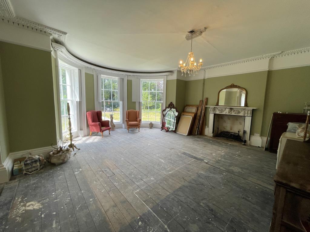 Lot: 151 - SUBSTANTIAL FORMER CARE HOME WITH POTENTIAL - Internal curved room with fireplace and windows
